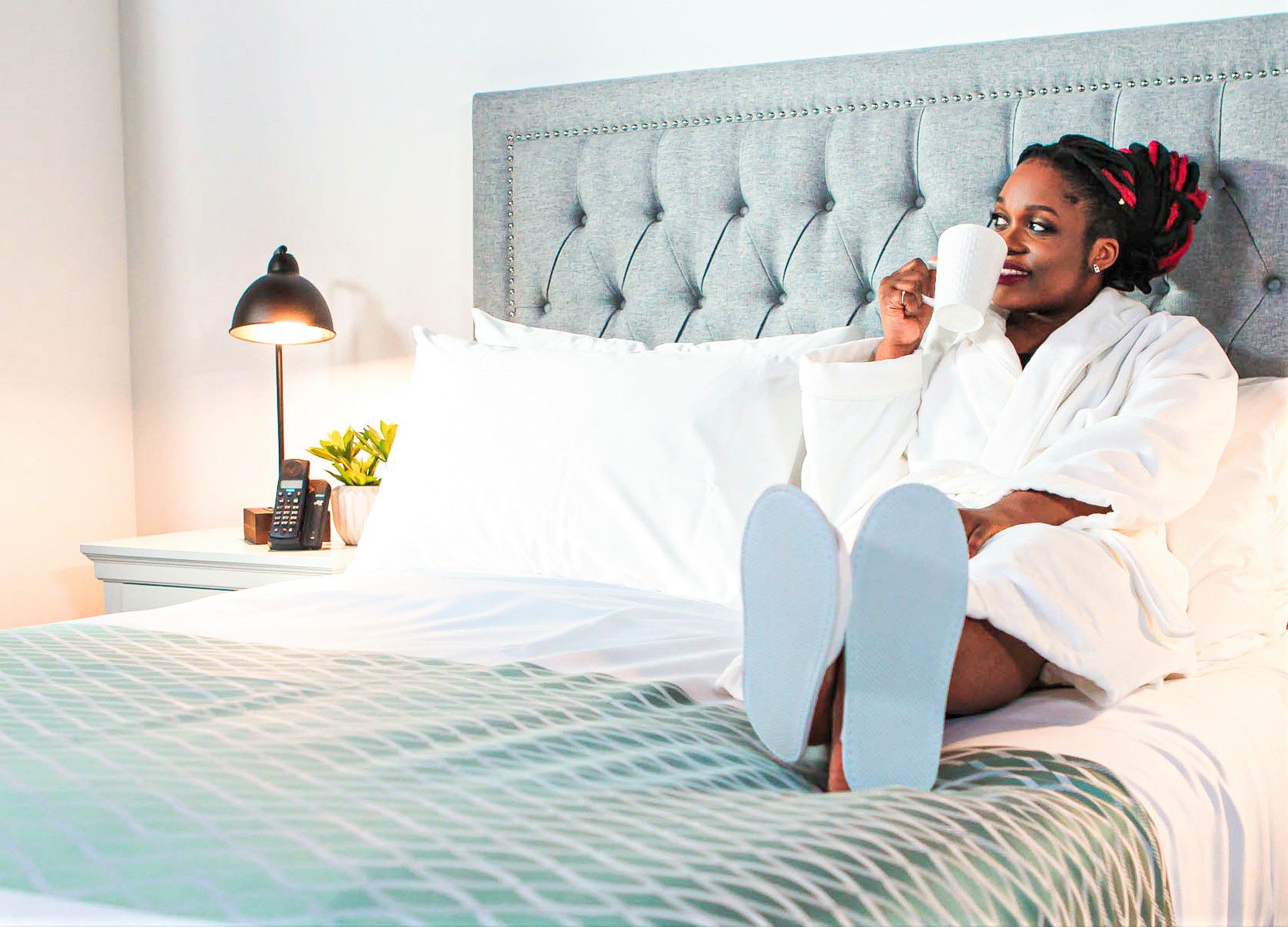 Hotel Guest Enjoying Comfort of Hotel Room with Top Sheet